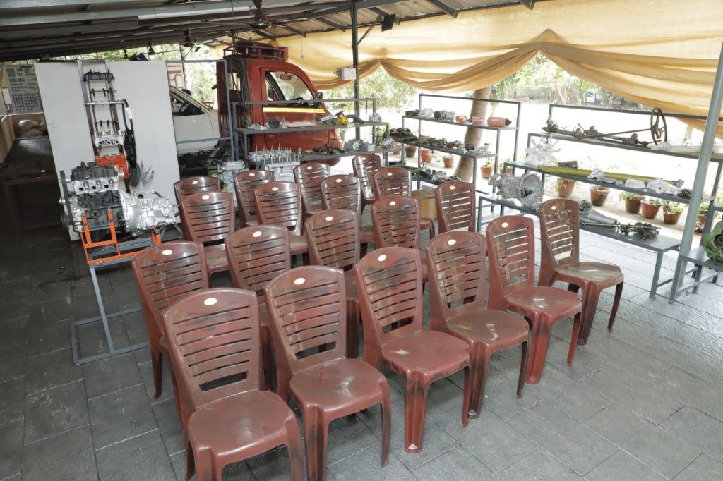 Training garage with engine cutaway model and spare parts