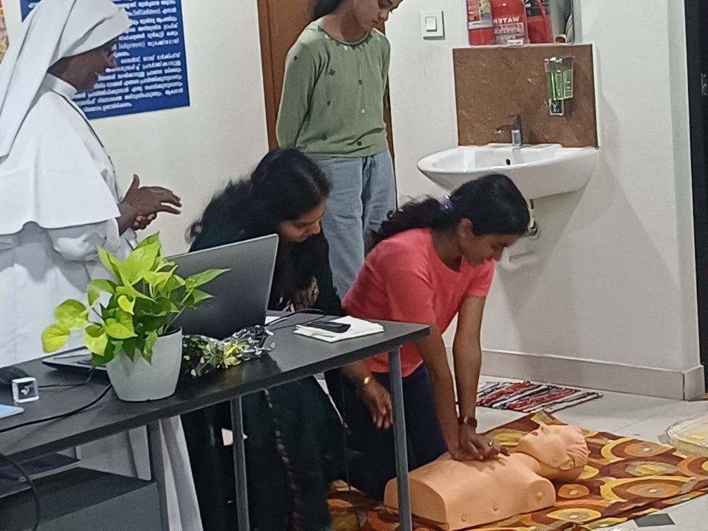 Student practicing CPR on a training dummy